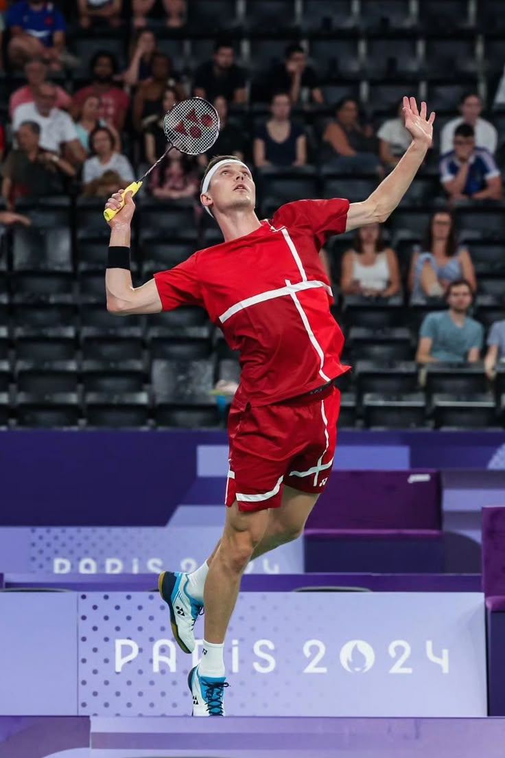 Player jumping for a smash in indoor gym